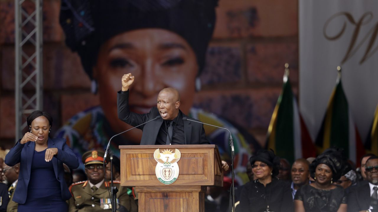 Winnie Madikizela-Mandela's image serves as a backdrop at her funeral Saturday at Orlando Stadium in Soweto, as Julius Malema, leader of the Economic Freedom Fighters populist opposition party, pays tribute to her.