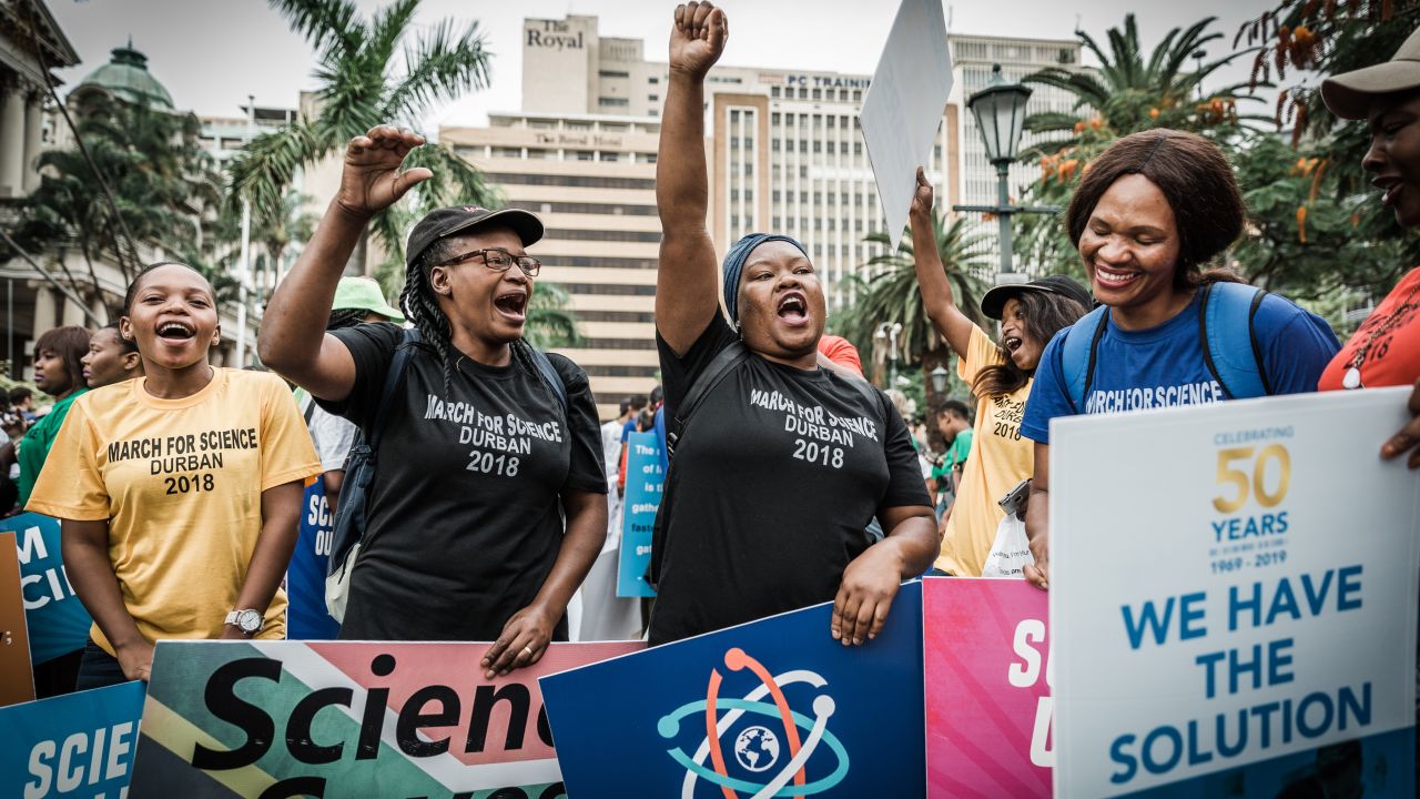People holding banners shout slogans during the March for Science in Durban, South Africa, on April 14.