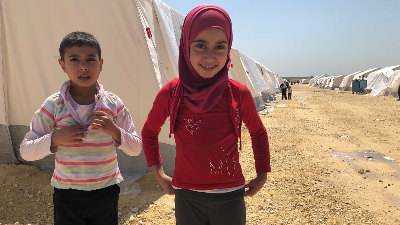 Ten-year-old girl Amira doesn't remember a time when her native neighborhood of Eastern Ghouta wasn't embroiled in war. Pictured at the al-Bol refugee camp in northern Syria with another evacuee, she says she wants to be a teacher when she grows up. 