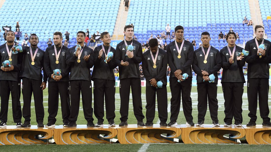 New Zealand players celebrate after defeating Fiji in the men's rugby sevens gold medal match at the Robina Stadium.
