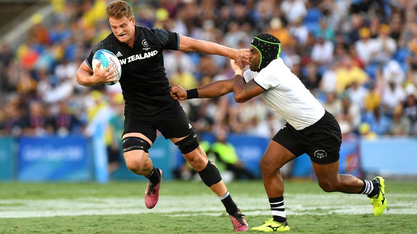 GOLD COAST, AUSTRALIA - APRIL 15: Scott Curry of New Zealand pushes away from the defence in the MenÕs Gold Medal Final match between Fiji and New Zealand during Rugby Sevens on day 11 of the Gold Coast 2018 Commonwealth Games at Robina Stadium on April 15, 2018 on the Gold Coast, Australia. (Photo by Bradley Kanaris/Getty Images)