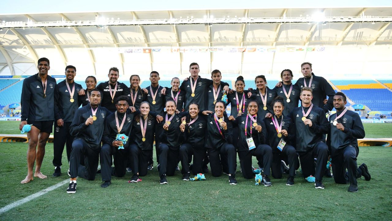 New Zealand men and women's team pose with their gold medals following their wins.