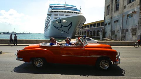 A classic American car rolls by the first American cruise ship to visit Cuba in decades. In 2016 the US restarted regular cruise ship service to the island, and for the first time since the Cuban revolution, US visitors came to Cuba in large numbers. Americans are still restricted to "permitted" forms of travel to the island, and President Donald Trump has enacted restrictions on where Americans can stay and spend money, to prevent their dollars from going into the pocket of the Cuban military.