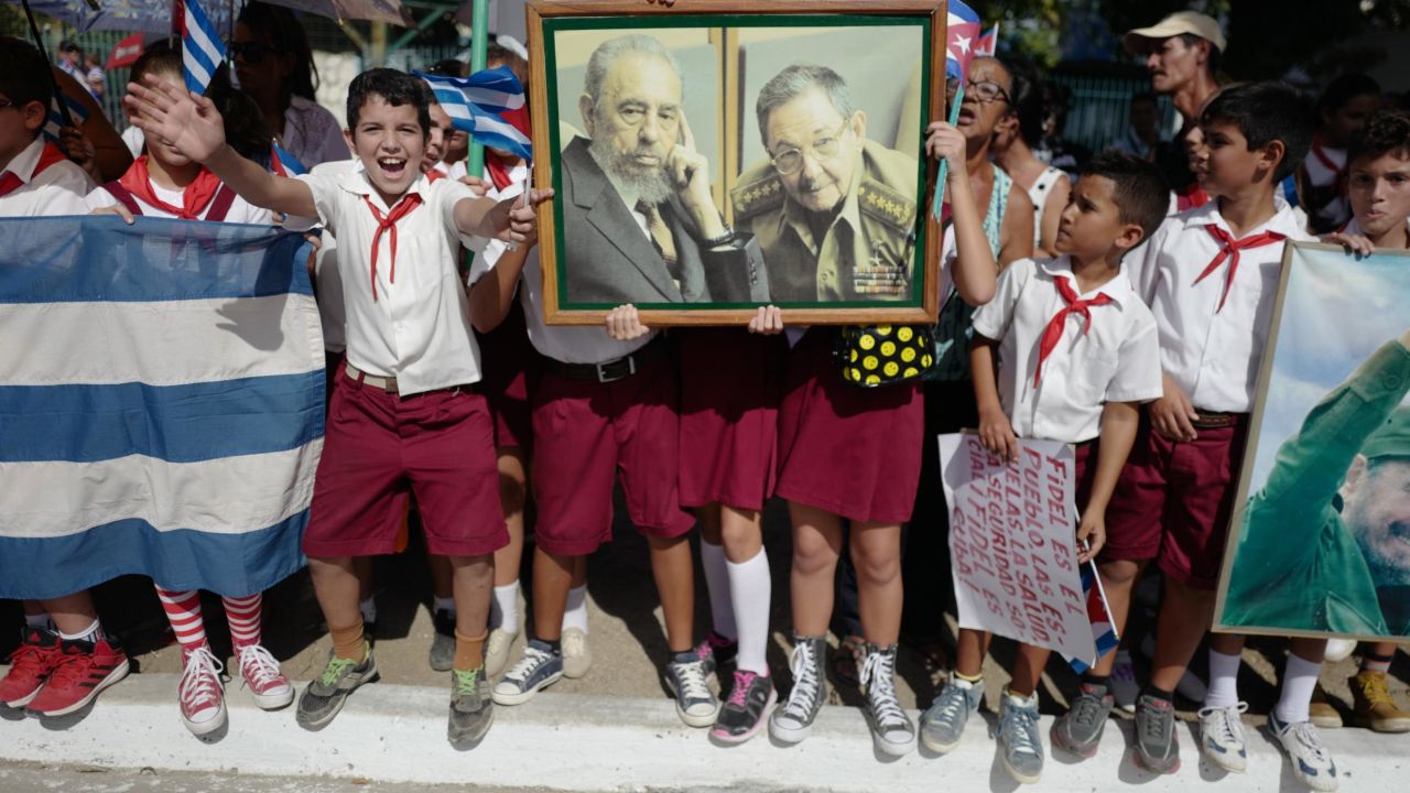 Cuban students greet Fidel Castro's funeral caravan in 2016 as it traveled through Holguín, Cuba, near where Castro was born. After Castro died at the age of 90, his ashes were driven through the island, retracing the route he took as a young guerrilla leader.  Upon taking power, Castro promised democratic elections but instead stayed in office for nearly 50 years.