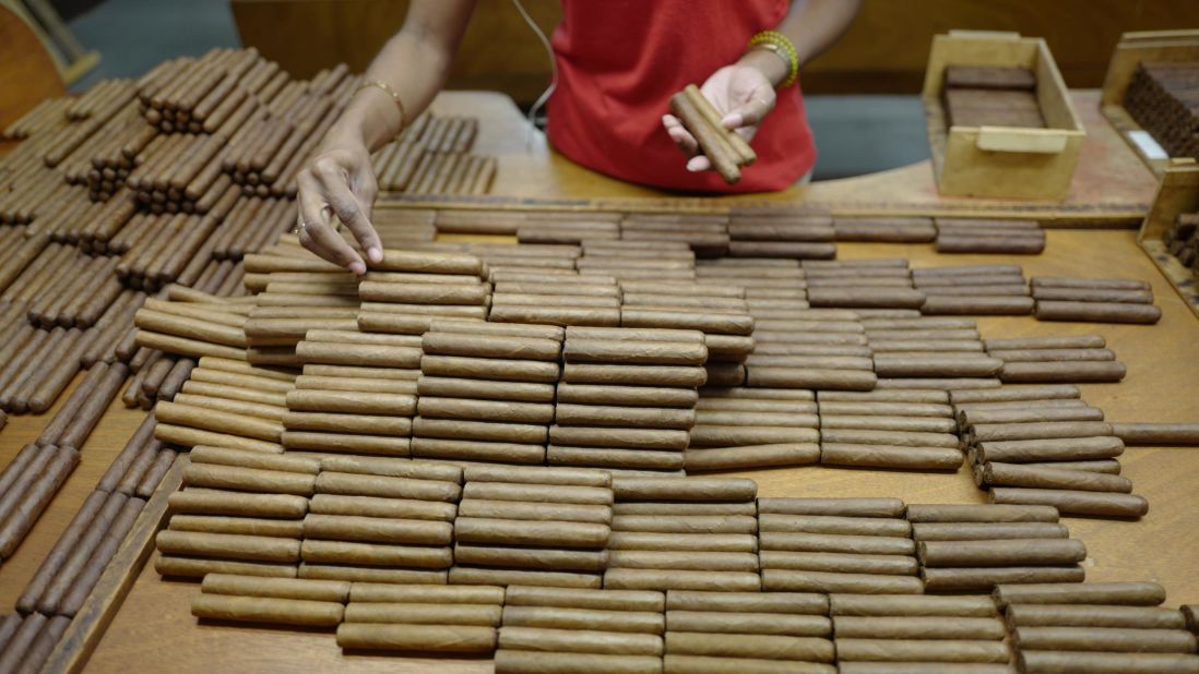 A worker at the Partagas factory in Havana sorts some of Cuba's famed cigars to ensure that each box contains tobacco of the same color. Cuban cigars are still rolled by hand as they have been for generations. For years, Cuban cigars were banned in the US, but as part of his shift in policy toward Cuba, President Obama changed the law to allow US citizens to bring habanos back from trips abroad. The US trade embargo still prohibits the sale of Cuban cigars in the US.