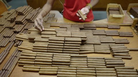 A worker at the Partagas factory in Havana sorts some of Cuba's famed cigars to ensure that each box contains tobacco of the same color. Cuban cigars are still rolled by hand as they have been for generations. For years, Cuban cigars were banned in the US, but as part of his shift in policy toward Cuba, President Obama changed the law to allow US citizens to bring habanos back from trips abroad. The US trade embargo still prohibits the sale of Cuban cigars in the US.