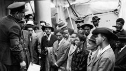 Jamaican immigrants welcomed by RAF officials from the Colonial Office after the ex-troopship  HMT 'Empire Windrush' landed them at Tilbury.   (Photo by PA Images via Getty Images)
