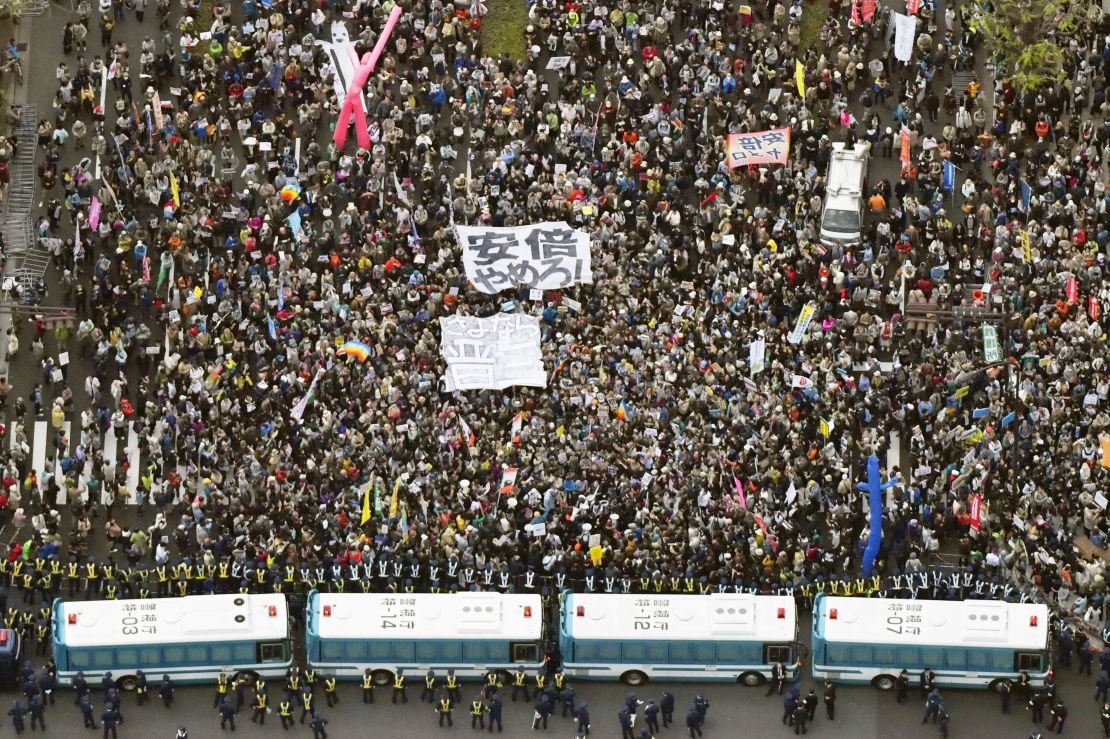 Crowds gather Saturday outside Japan's Diet to demand Prime Minister Shinzo Abe's resignation.