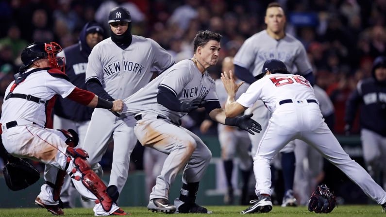 New York Yankees' Tyler Austin, center, is held back by Red Sox catcher Christian Vazquez as Austin rushes Boston Red Sox relief pitcher Joe Kelly, right, after <a href="index.php?page=&url=http%3A%2F%2Fbleacherreport.com%2Farticles%2F2770075-yankees-vs-red-sox-erupts-in-brawl-after-joe-kelly-hits-tyler-austin-with-pitch" target="_blank" target="_blank">being hit by a pitch</a> during a baseball game at Fenway Park on Wednesday, April 11. The hit led to a <a href="index.php?page=&url=http%3A%2F%2Fbleacherreport.com%2Farticles%2F2770229-joe-kelly-suspended-5-games-tyler-austin-6-for-red-sox-vs-yankees-brawl" target="_blank" target="_blank">bench-clearing brawl</a> and left Kelly and Austin suspended for five and six games, respectively. 