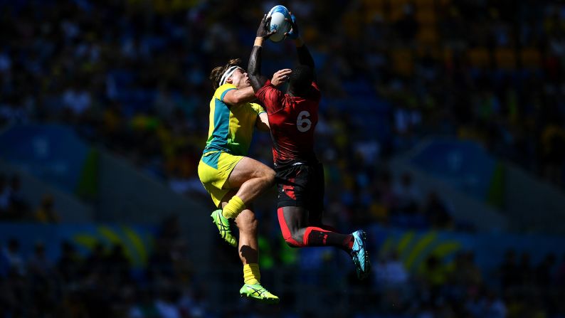 Charlie Taylor of Australia, left, vies for the high ball with Jeff Oluoch of Kenya during the Rugby Sevens men's placing 5-8th match on day 11 of the Commonwealth Games on the Gold Coast in Australia on Sunday, April 15.
