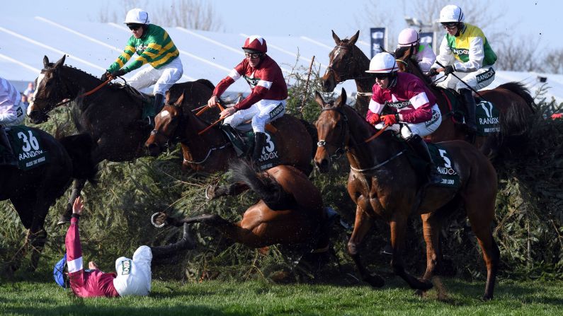 Jockey Rachael Blackmore is unseated from Alpha Des Obeaux during the Grand National horse race at Aintree Racecourse in Liverpool, England, on Saturday, April 14. Both horse and rider were in good condition after the fall.