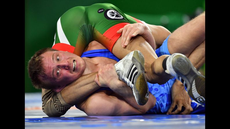 Scotland's Oleg Gladkov, in blue, wrestles with Pakistan's Muhammad Asad Butt during the men's freestyle 74 kilogram wrestling match at the Commonwealth Games on the Gold Coast in Australia on Thursday, April 12.