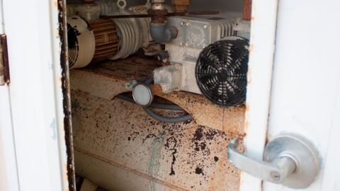A blown-out door at Vieques' hospital, now condemned, reveals machinery corroded by moisture.