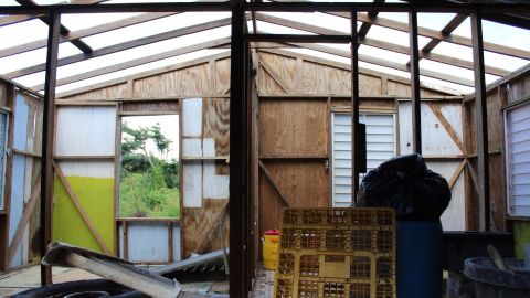 Next door to Martina Collazo de Jesus' home, Joe Garcia's house lies in ruins. Garcia has managed to reattach metal siding on the frame.