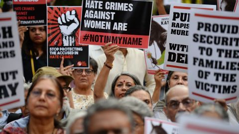 Indian demonstrators hold placards during an anti-rape protest in New Delhi on April 15, 2018. 