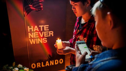 A Chinese man lights a candle at a memorial vigil for the victims of the mass shooting at the Pulse nightclub, at Adam's Bar on June 14, 2016 in Beijing, China.