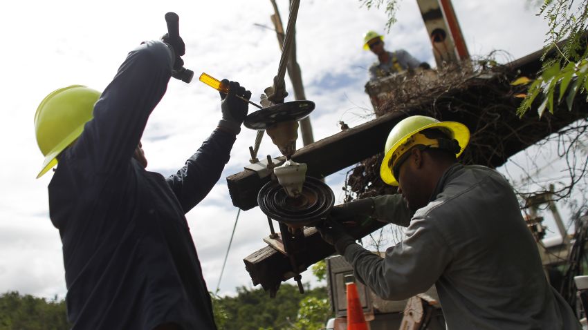 A Puerto Rico Electric and Power Authority brigade work in a remote off-road location to repair a downed power transmission line in Ponce, Puerto Rico on November 29, 2017. / AFP PHOTO / Ricardo ARDUENGO / TO GO WITH AFP STORY By Leila MACOR, US-PuertoRico-power-weather-reconstruction-hurricane        (Photo credit should read RICARDO ARDUENGO/AFP/Getty Images)