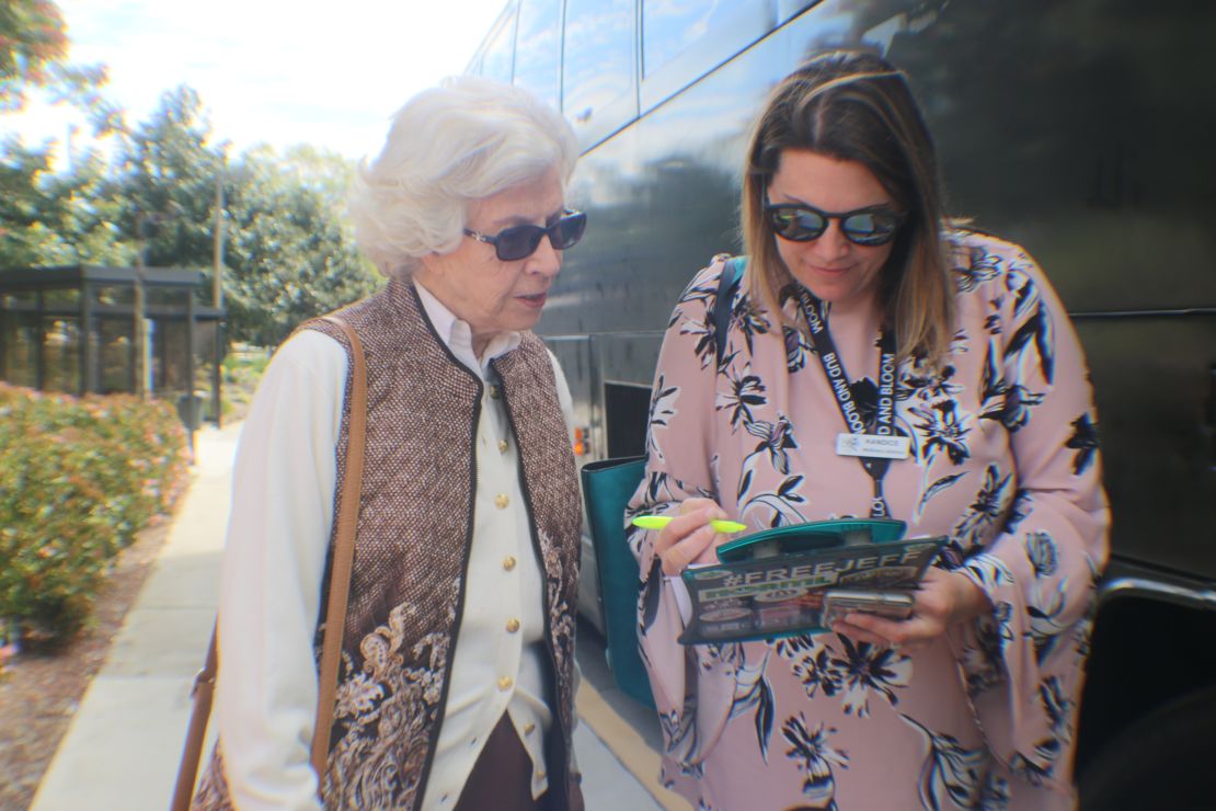 Seniors check in with Kandice Hawes before boarding a charter bus to a medical marijuana dispensary.