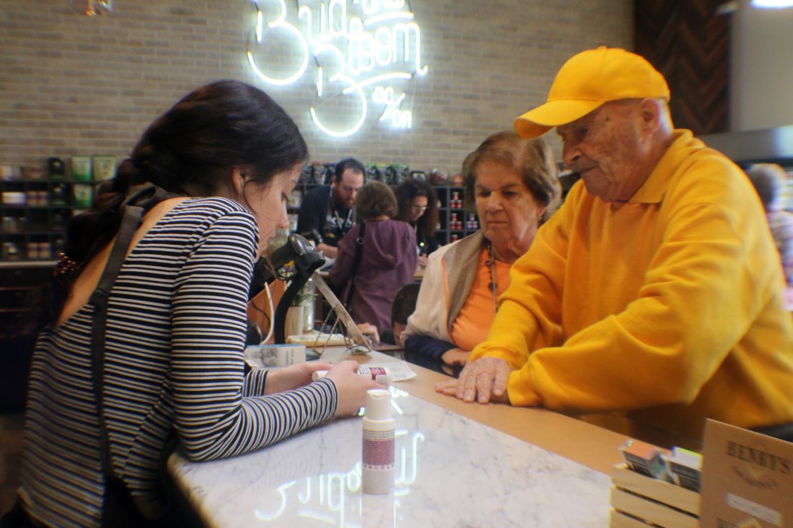 John and Anne Lustig learn about cannabis lotions at the dispensary.