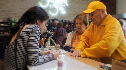 John and Anne Lustig learn about cannabis lotions at the dispensary.