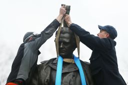 Parks Department workers place a harness over a statue of James Marion Sims as they prepare to take it down on Tuesday.