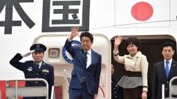 Japan's Prime Minister Shinzo Abe (2nd L) and his wife Akie wave as they prepare to depart from Tokyo's Haneda airport on April 17, 2018.
US President Donald Trump hosts Japan's Shinzo Abe at his Mar-a-Lago resort on April 17, with both men under pressure to deliver something more than bonhomie and birdies. / AFP PHOTO / Kazuhiro NOGI        (Photo credit should read KAZUHIRO NOGI/AFP/Getty Images)
