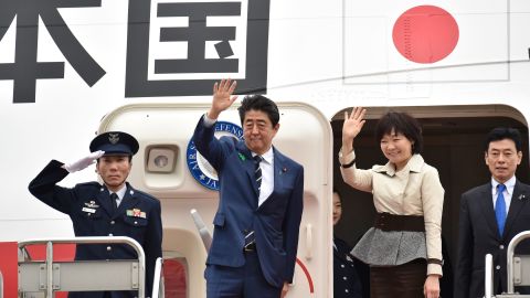 Japan's Prime Minister Shinzo Abe (2nd left) and his wife Akie wave as they prepare to depart from Tokyo's Haneda airport on April 17, 2018. 