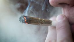 Man smoking marijuana cigarette soft drug in Amsterdam, Netherlands