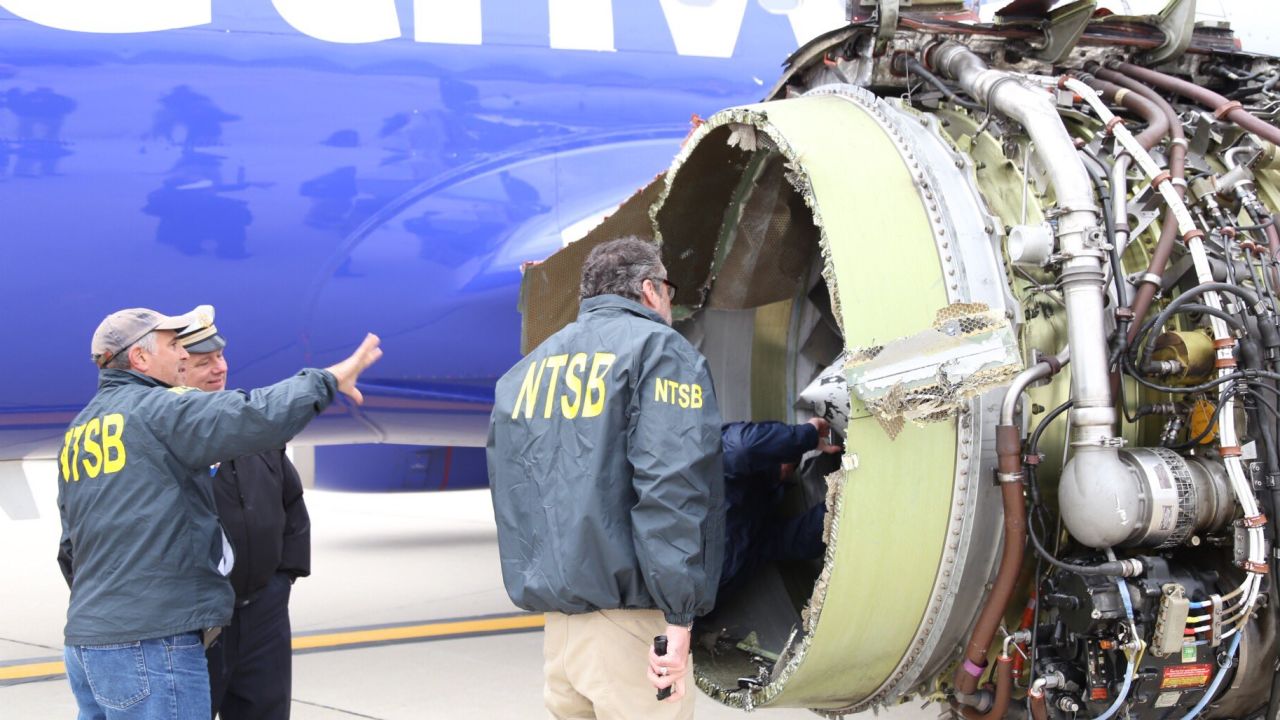 A team from the National Transportation Safety Board inspects a Southwest Airlines plane after engine failure caused the plane to make an emergency landing at Philadelphia International Airport.