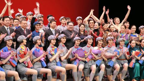 North Korean leader Kim Jong Un, center, claps while posing with Song Tao and members of a Chinese art troupe in Pyongyang.