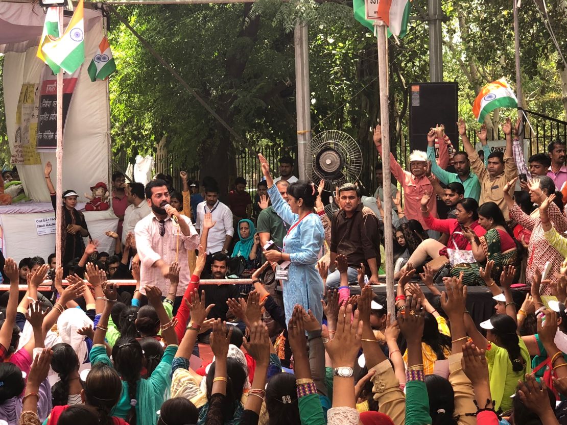 A women's rights activist addresses a rally of hundreds of Maliwal's supporters.