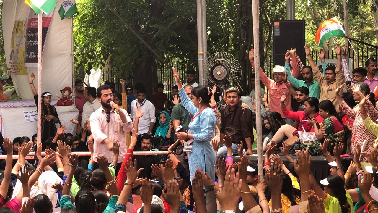 A women's rights activist addresses a rally of hundreds of Maliwal's supporters.