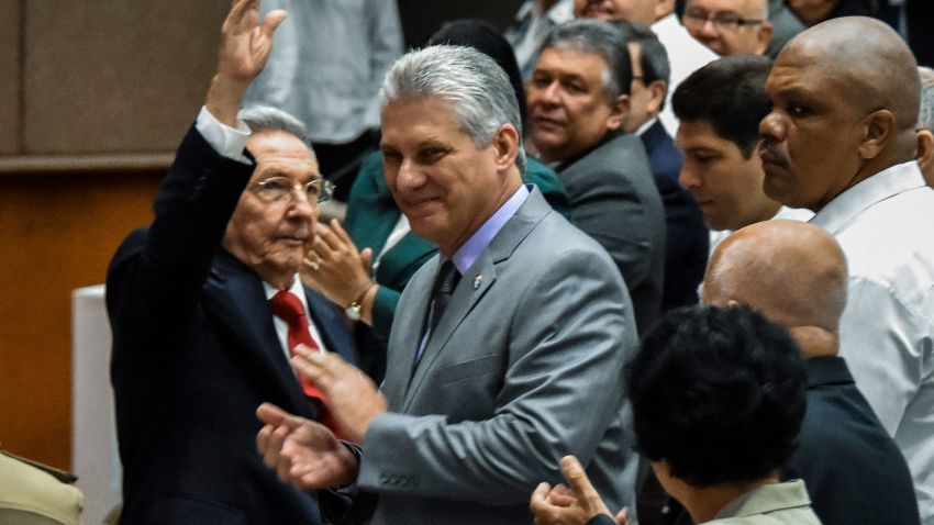TOPSHOT - Cuban President Raul Castro (L) waves next to First Vice-President Miguel Diaz-Canel (C) during a National Assembly session that will select Cuba's Council of State ahead of the naming of a new president, in Havana on April 18, 2018.
Cuban President Raul Castro steps down Thursday, passing the baton to a new generation in a transition that brings to a close the Castro brothers' six-decade grip on power. The 86-year-old has been in power since 2006, when he took over after illness sidelined his brother Fidel, who seized power in the 1959 revolution. / AFP PHOTO / STR        (Photo credit should read STR/AFP/Getty Images)
