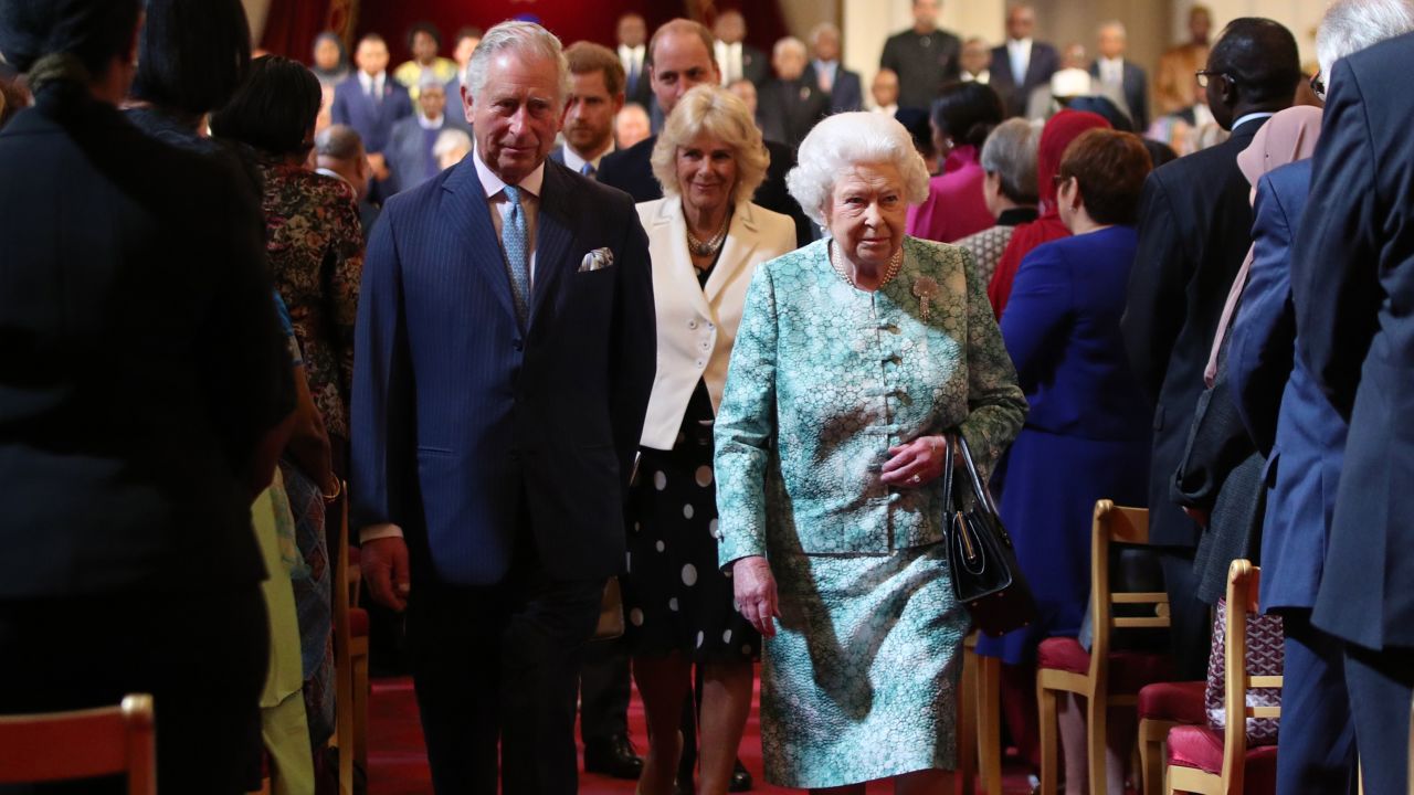 Queen Elizabeth II and Prince Charles arrive for the formal opening of the Commonwealth Heads of Government Meeting at Buckingham Palace in London on Thursday.