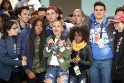  Students from Marjory Stoneman Douglas High School, including Emma Gonzalez, stand together on stage with other young victims of gun violence at the conclusion of the March for Our Lives rally on March 24, 2018, in Washington, DC. 