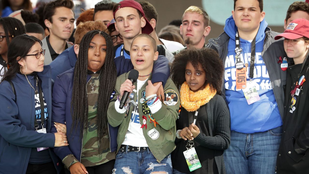  Students from Marjory Stoneman Douglas High School, including Emma Gonzalez, stand together on stage with other young victims of gun violence at the conclusion of the March for Our Lives rally on March 24, 2018, in Washington, DC. 
