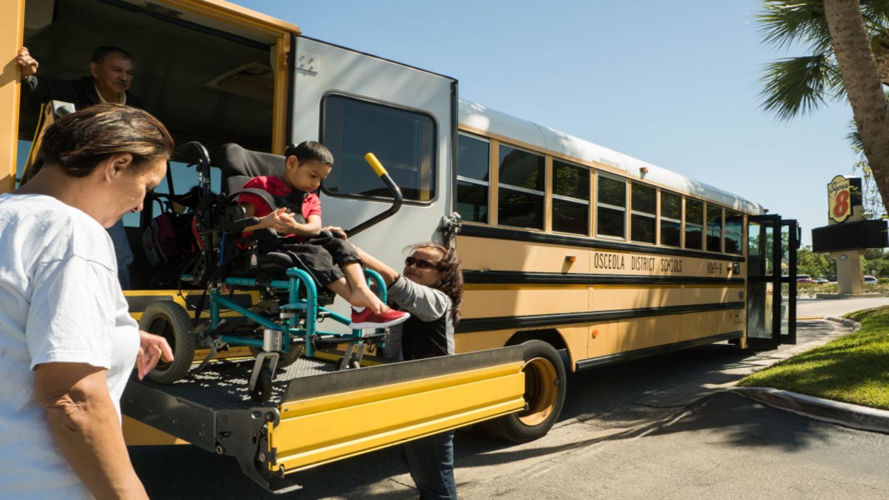 School buses drop off children who evacuated Puerto Rico at motels along US Highway 192 in Kissimmee, Florida.