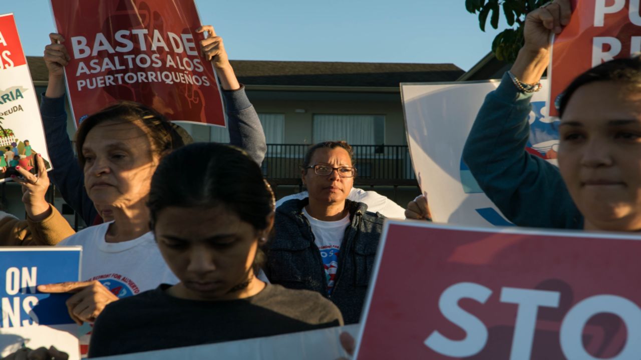 Carmen "Millie" Santiago, center, protests for an extension of FEMA motel aid on April 16.
