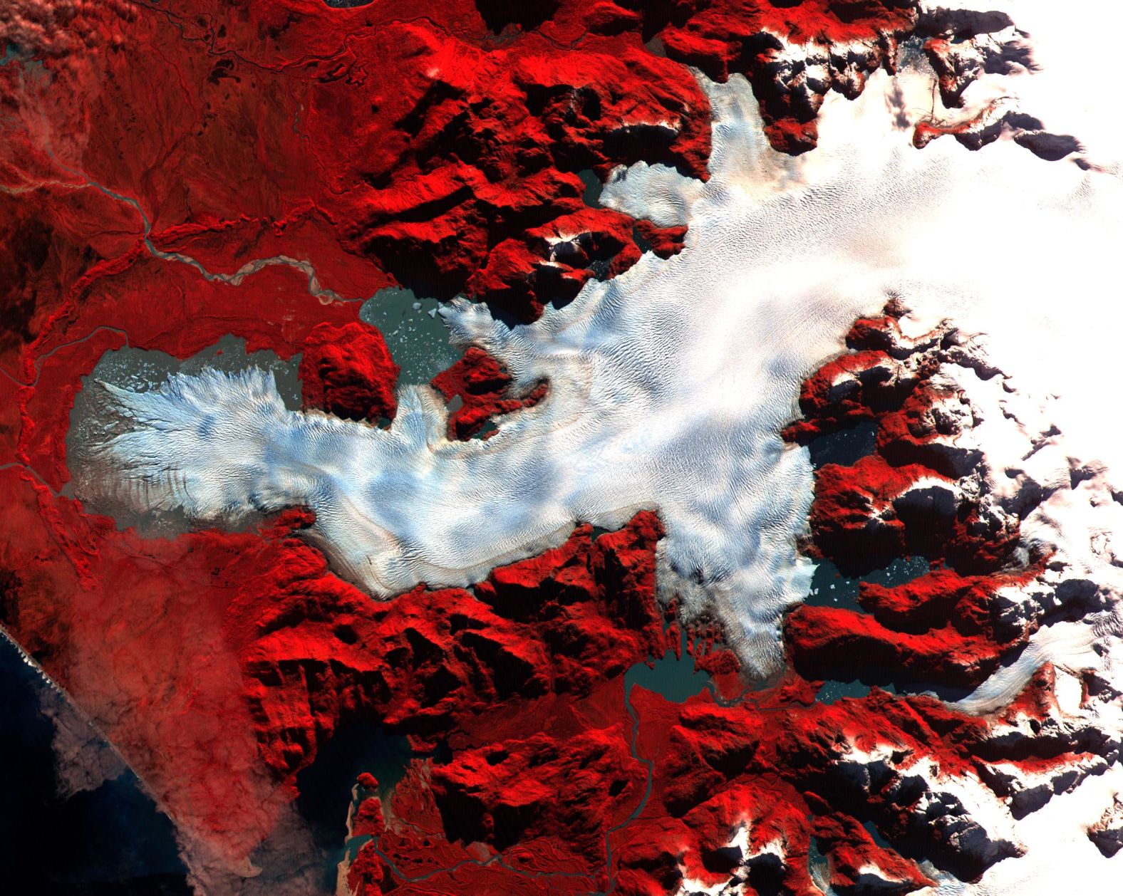 <strong>Patagonia, Chile:</strong> NASA uses ASTER images to monitor shrinking glaciers, as an indicator of global warming. Pictured here, an ice sheet in Northern Patagonia features assigned colors -- with vegetation in red -- to measure the glacier's size over time.  