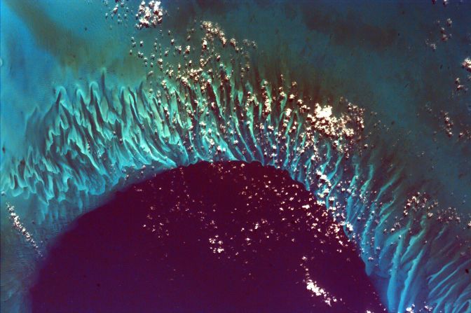 <strong>Grand Bahama Bank</strong>: Taken by EarthKAM, this surreal image depicts the Grand Bahama Bank, where the deep water of Tongue of the Ocean (an underwater canyon) mixes with the shallow shoals of the archipelago.  