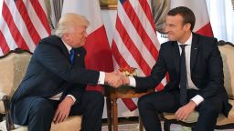 TOPSHOT - US President Donald Trump (L) and French President Emmanuel Macron (R) shake hands ahead of a working lunch, at the US ambassador's residence, on the sidelines of the NATO (North Atlantic Treaty Organization) summit, in Brussels, on May 25, 2017. / AFP PHOTO / Mandel NGAN        (Photo credit should read MANDEL NGAN/AFP/Getty Images)