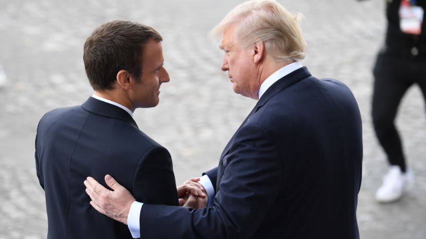 TOPSHOT - French President Emmanuel Macron (L) bids farewell to his US counterpart Donald Trump after the annual Bastille Day military parade on the Champs-Elysees avenue in Paris on July 14, 2017.Bastille Day, the French National Day, is held annually each July 14, to commemorate the storming of the Bastille fortress in 1789. This years parade on Paris's Champs-Elysees will commemorate the centenary of the US entering WWI and will feature horses, helicopters, planes and troops. / AFP PHOTO / ALAIN JOCARD        (Photo credit should read ALAIN JOCARD/AFP/Getty Images)
