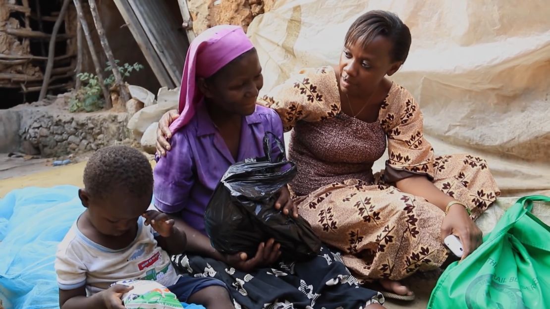 Phyllis Omido meets with Catherine Okello and her son, Sammy, in 2014. They are both suffering from lead related illnesses. Both have since died from lead-related illnesses since this picture was taken. 