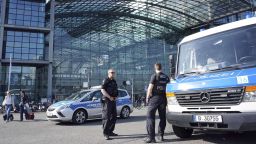 Police officers stay in front of the main train station in Berlin, Germany, Friday, April 20, 2018. Berlin police are evacuating thousands from a central area of the German capital and shutting down the main train station in preparation for the removal of an unexploded World War II bomb found during recent construction work. (AP Photo/Michael Sohn)