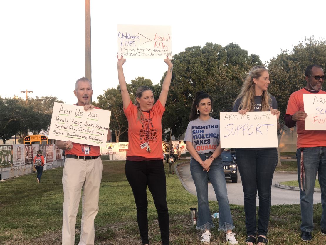 Teachers at Florida's Marjory Stoneman Douglas High School demonstrate before classes Friday.