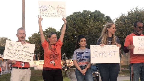 Teachers at Florida's Marjory Stoneman Douglas High School demonstrate before classes Friday.