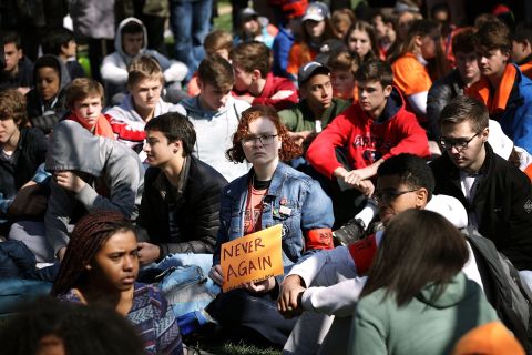 Several hundred high school students from the Washington area observe 19 minutes of silence while rallying in front of the White House before marching to the US Capitol.