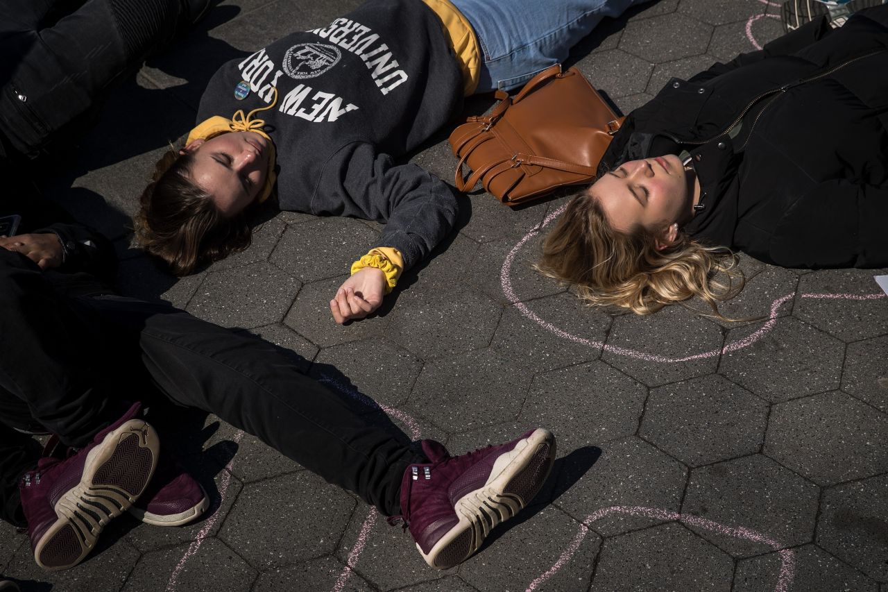 Student activists participate in a "die-in" to protest gun violence at Washington Square Park in New York.
