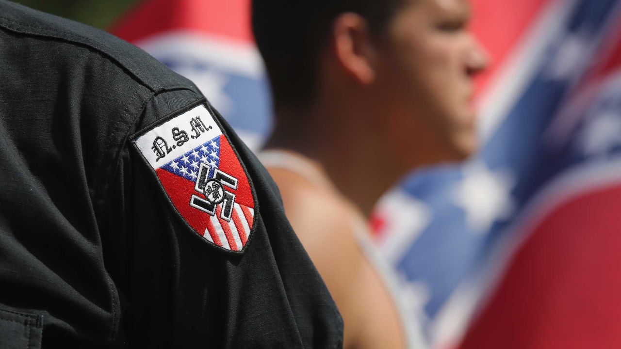 COLUMBIA, SC - JULY 18:  Neo Nazis (National Socialist Movement) take part in a Ku Klux Klan demonstration at the state house building on July 18, 2015 in Columbia, South Carolina. The KKK protested the removal of the Confederate flag from the state house grounds, as law enforcement tried to prevent violence between the opposing groups.  (Photo by John Moore/Getty Images)