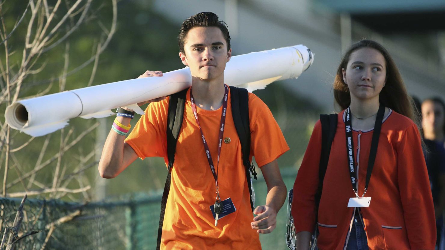 Marjory Stoneman Douglas student David Hogg walks to school with a large rolled banner over his shoulder on Friday, April 20, 2018 in Parkland, Florida
